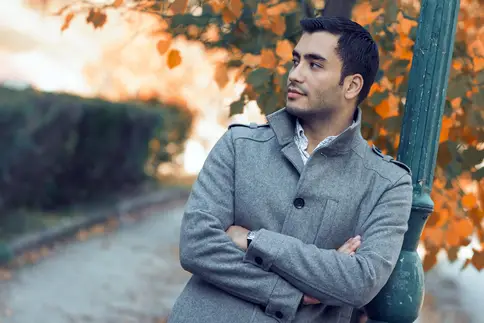 photo of young man relaxing outside on fall day